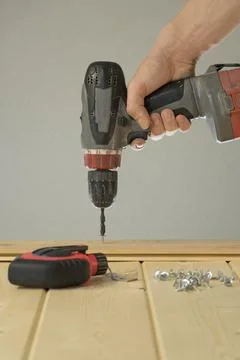 Screw in the screw with a screwdriver. Tools for construction. Do home repair 스톡 사진