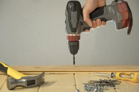 Screw in the screw with a screwdriver. Tools for construction. Do home repair Stock Photos