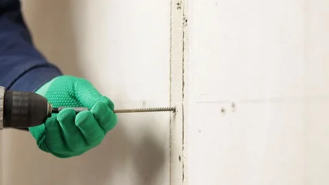 Screw the screw into the wall Stock Footage 129137859