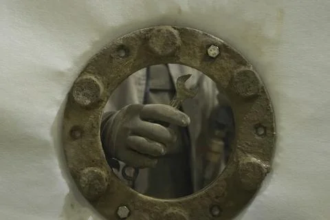 Screw the stud and nut with your hand when attaching the flange to the wall.. Stock Photos