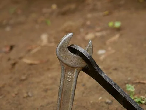 Screw tools hardware jointing together presented on soil filed for industrial Stock-Fotos
