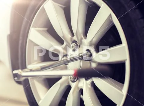 Screwdriver and car wheel tire Stock Photos