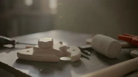 Screwdriver and elements of furniture on the table in the carpentry shop, close- Stock Footage 219347202
