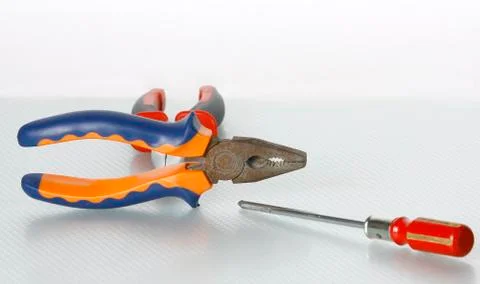 Screwdriver and pliers tools set isolated over white background. Stock Photos