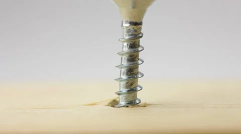 Screwdriver and screw in timber panel Stock Footage 34395644