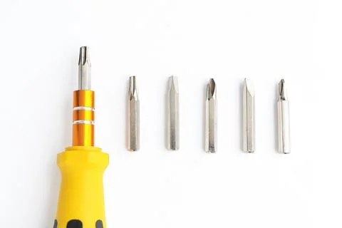 Screwdriver and Set of heads for screwdriver (bits) on a white background.  Stock Photos