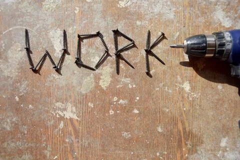 Screwdriver and the word work made with screws Stock Photos
