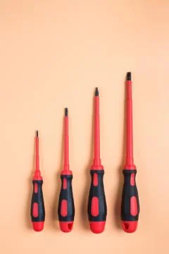 Screwdriver are an orange background, top view, a place for an inscription Stock Photos