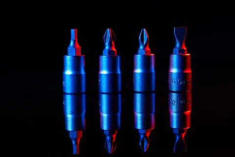 Screwdriver bits on black background with reflections. Mixed lighting Stock Photos