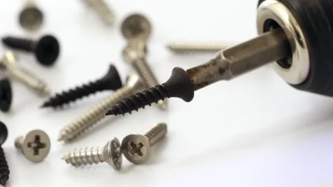 Screwdriver with a black screw head, rotating at low speed Vídeo Stock 322927359
