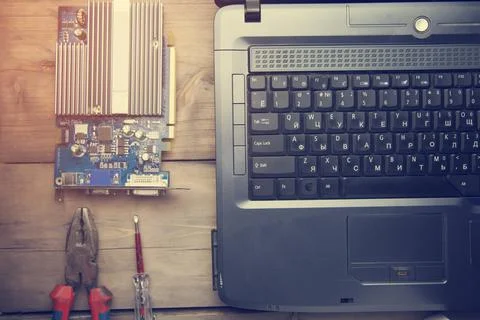 Screwdriver on the computer Stock Photos