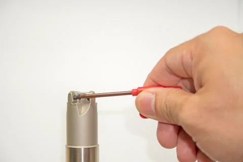 Screwdriver of cutting machine tool by hand Stock Photos