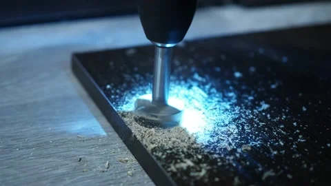 A screwdriver with a drill for the hinge holes. we drill a hole in the furniture Stock Footage 146155687