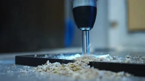 With a screwdriver with a drill, we drill a hole for the furniture loop. door Stock Footage 146155626