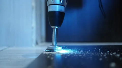 With a screwdriver with a drill, we drill a hole for the furniture loop Stock Footage 146206476