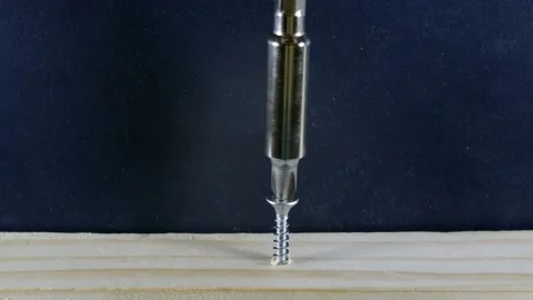 The screwdriver drives the screw into the wood. 스톡 동영상 138264751