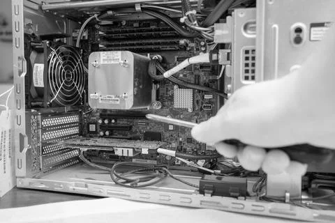 Screwdriver is held in an unscrewed PC Stock Photos