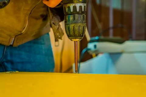 A screwdriver inserted into the screw head. Foto stock