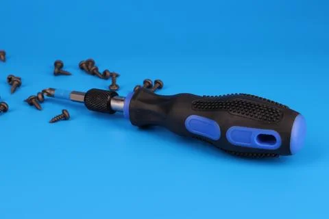 Screwdriver with an insulated handle for installing equipment. Stock Photos