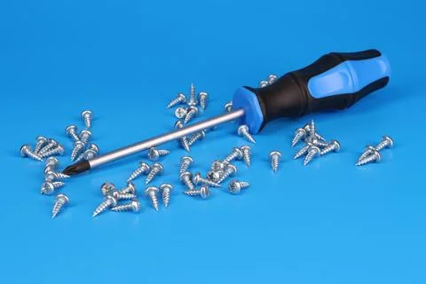 Screwdriver with an insulated handle for installing equipment. Stock Photos