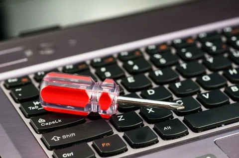 A screwdriver on the keyboard of the notebook computer Foto stock