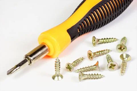 A screwdriver is a locksmith tool for tightening fixing screws. Stock Photos