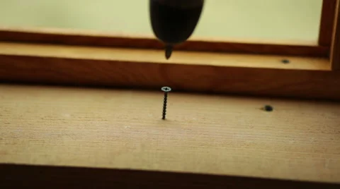 Screwdriver screw twists into the board Stock Footage 53267887