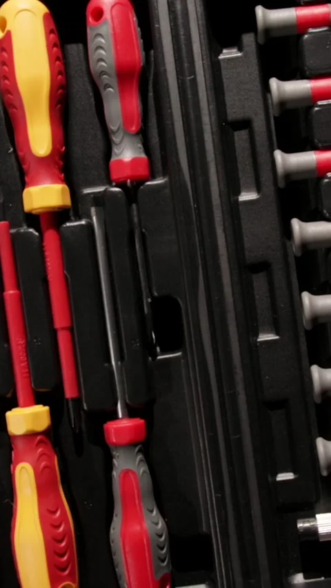 Screwdriver set arranged on a black tool organizer for efficient access Stock Footage 320752720