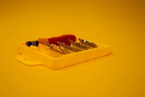 Screwdriver with small bits on a bright background Stock Photos