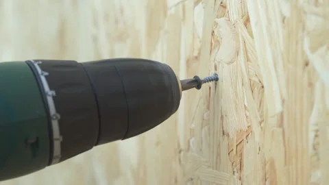 Screwdriver tip screwing a screw in a piece of wood. Stock Footage 195536748