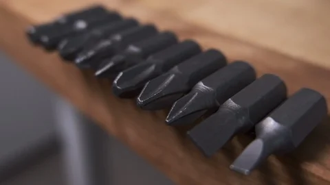 Screwdriver tips on a wooden bench. Close up, shallow depth of field. Stock Footage 119239048