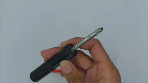 A screwdriver is a tool used to tighten or loosen bolts Stock Footage 245491689