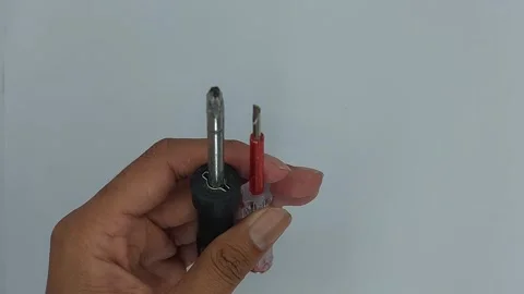 A screwdriver is a tool used to tighten or loosen bolts Stock Footage 245491894