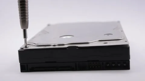 Screwdriver unscrews the screw from the Internal hard disk drive. Stock Footage 154158869