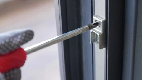 Screwdriver is used to fix a door lock Stock Footage 341907835