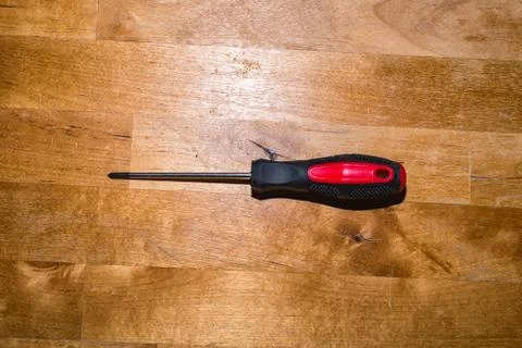 Screwdriver on the working surface I Stock Photos