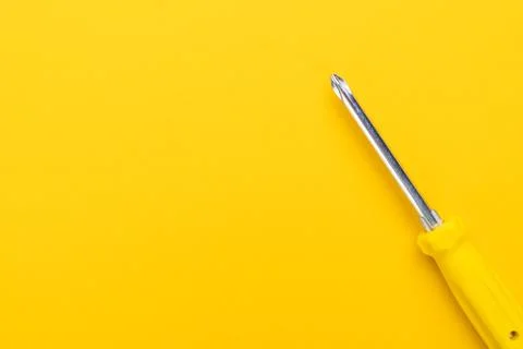 Screwdriver on yellow background Stock Photos