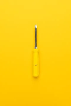 Screwdriver on yellow background Stock Photos