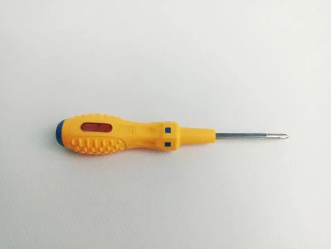 Screwdriver with yellow handle on white background,Also functions as a test pen Foto stock