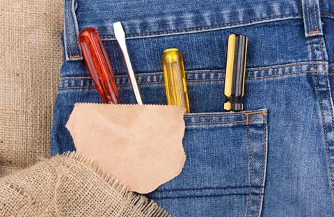 Screwdrivers in jeans pocket with blank note paper Stock Photos