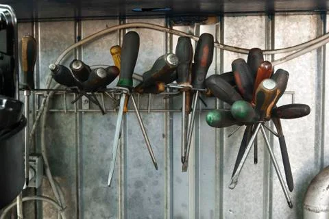 Screwdrivers on a stand in a dirty workshop Stock Photos