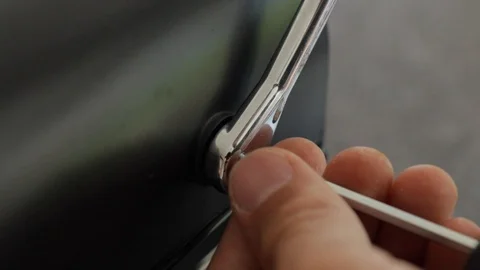 Screwing back torx screw into modern coffee machine handle, close-up still Vidéo 111285839