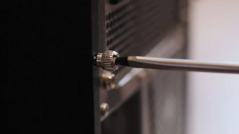 Screwing the bolt on the back of the computer Video stock 86360713