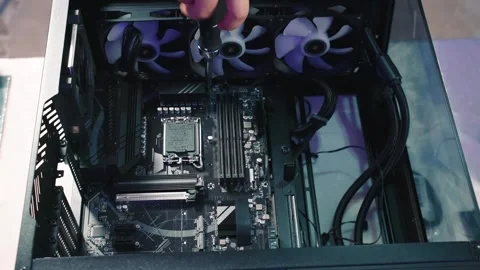 Screwing bolt into motherboard during computer assembly process Stock Footage 328985644