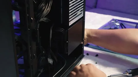 Screwing of the drive cage with hard drive and SSD to the computer case Stock-Footage 328987718