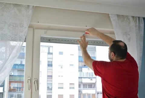 Screwing an element in i window frame Stock Photos