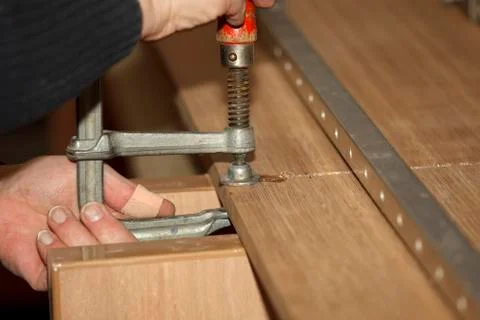 Screwing a glue clamp Stock Photos