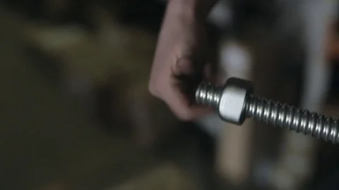 Screwing a Hex Nut onto a Threaded Rod Stock Footage 77024271
