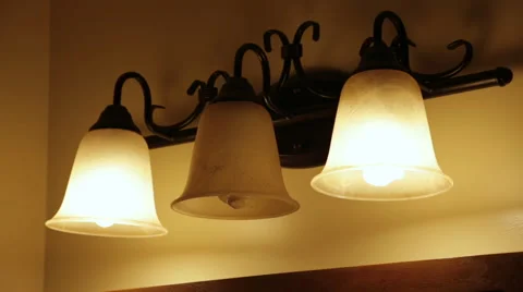 Screwing in a light bulb into a fixture Stock Footage 67274334