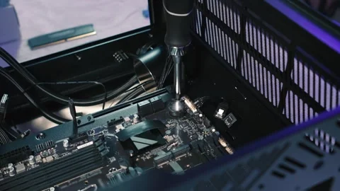 Screwing motherboard to computer case during assembly Stock Footage 328985656